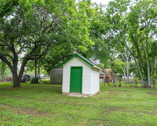 view of outbuilding with a yard