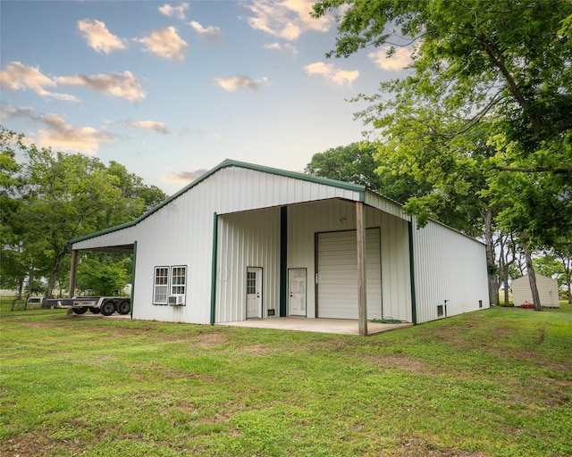 view of outbuilding featuring a yard