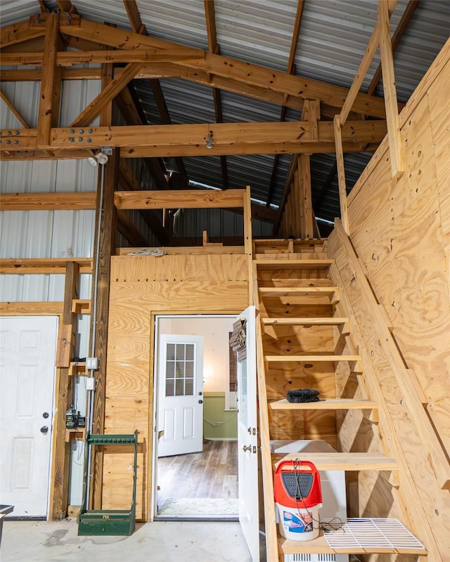 interior space with concrete flooring and wood walls