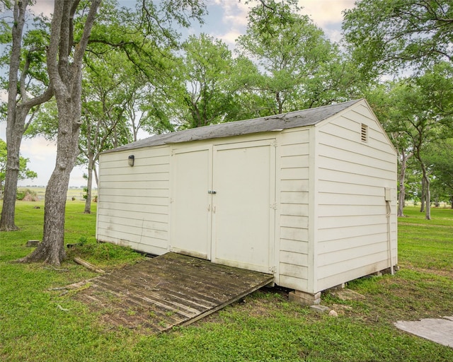 view of outbuilding with a lawn