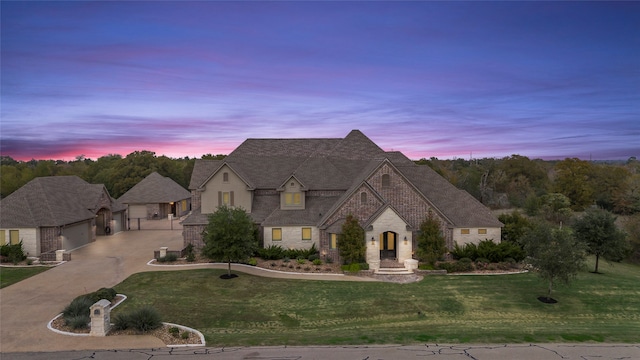 french country style house with a lawn