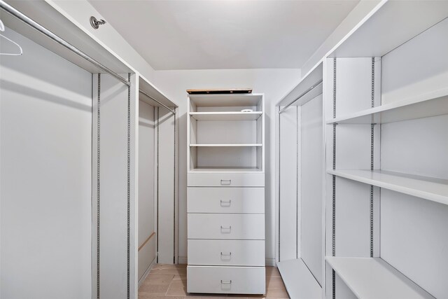 spacious closet featuring light tile floors