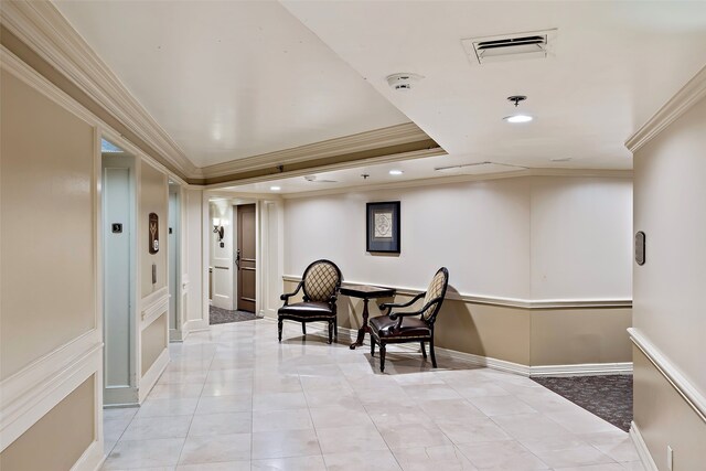 living area featuring a tray ceiling, light tile floors, and crown molding