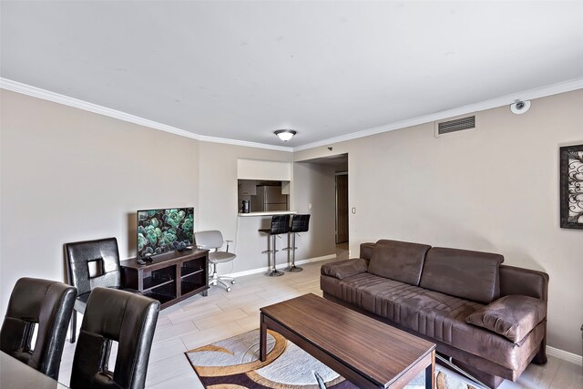 tiled living room featuring ornamental molding