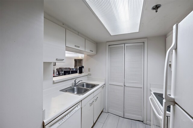 kitchen featuring white cabinetry, light tile floors, white appliances, and sink