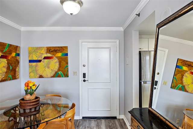 entryway with dark hardwood / wood-style flooring and crown molding