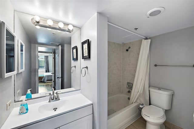 full bathroom featuring vanity with extensive cabinet space, toilet, tile floors, and shower / bathtub combination with curtain