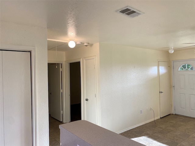 foyer featuring dark tile floors