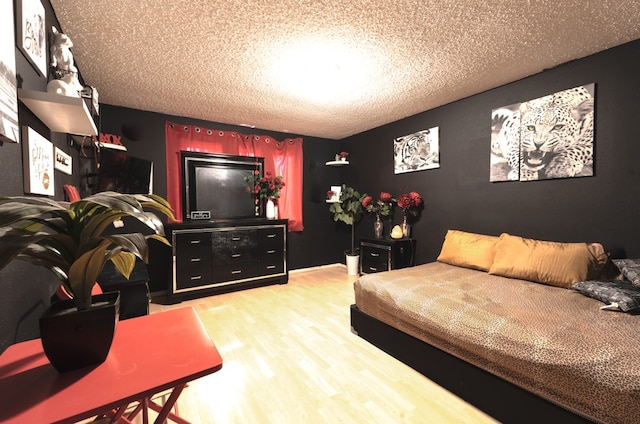 bedroom with wood-type flooring and a textured ceiling