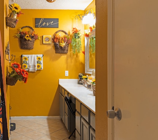 bathroom with a textured ceiling, vanity, and tile floors