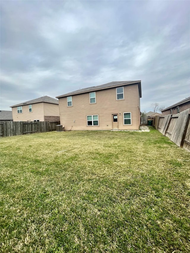 rear view of property with a lawn