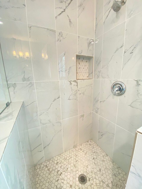 bathroom with a tile shower