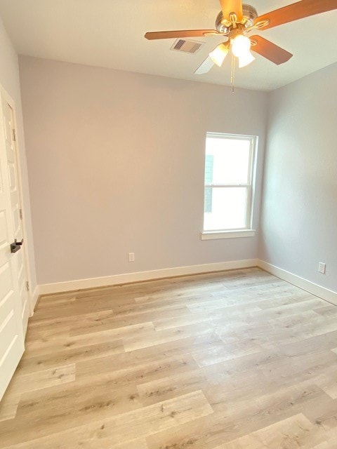 unfurnished room with light wood-type flooring and ceiling fan