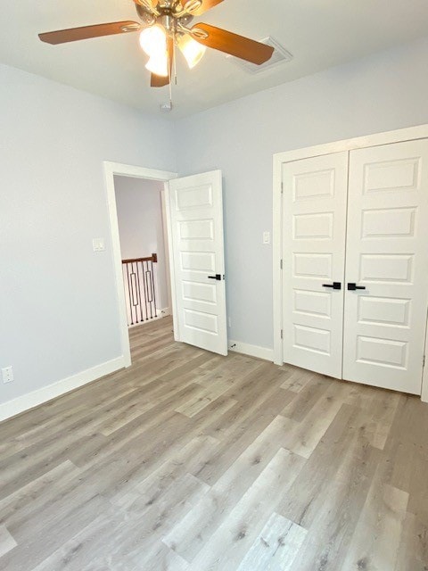 unfurnished bedroom with light wood-type flooring, a closet, and ceiling fan