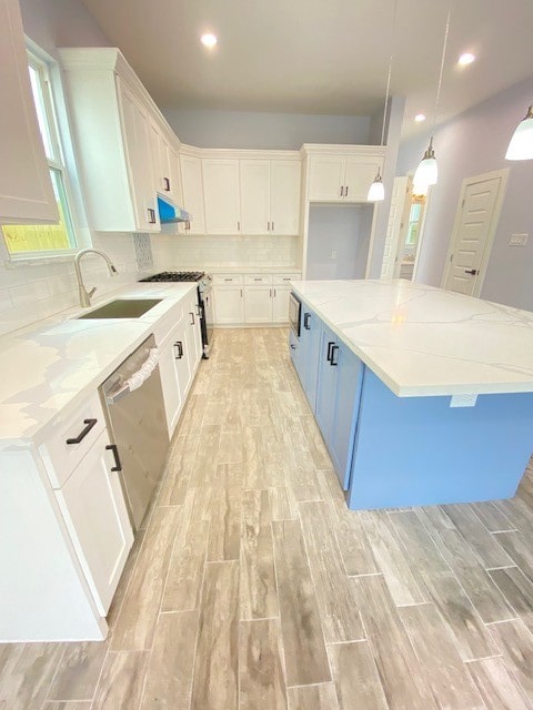 kitchen with pendant lighting, white cabinetry, and a spacious island