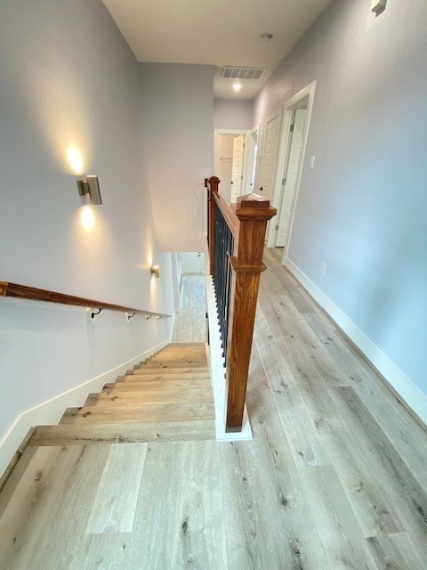 stairway featuring wood-type flooring