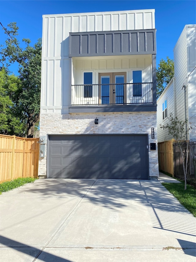 contemporary home featuring a garage and a balcony