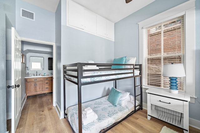 bedroom featuring multiple windows and light wood-type flooring