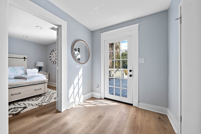 doorway to outside with light wood-type flooring