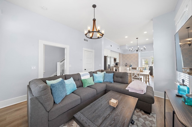 living room with dark hardwood / wood-style floors and a chandelier