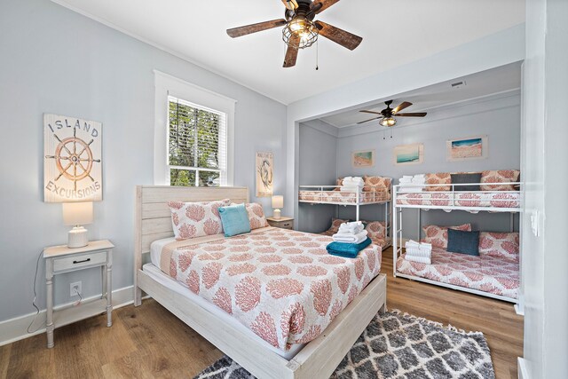 bedroom with ceiling fan and dark hardwood / wood-style flooring