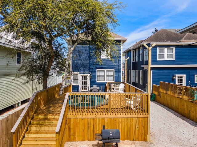 rear view of property featuring a wooden deck