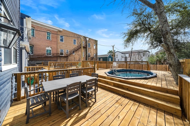 wooden deck featuring a pool with hot tub