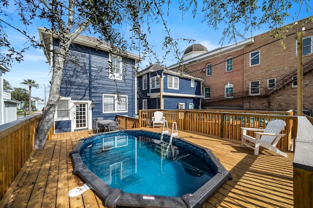 view of swimming pool featuring a wooden deck