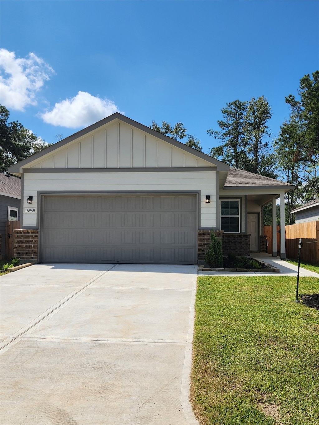 single story home featuring a garage and a front yard