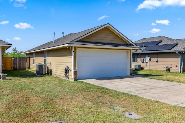 view of side of property with central AC, a lawn, and a garage