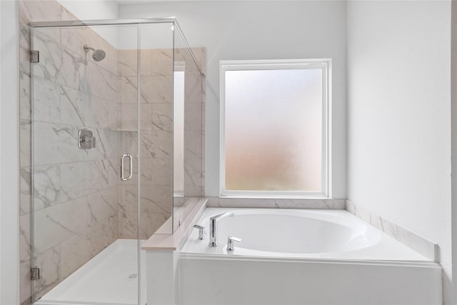 bathroom with shower with separate bathtub