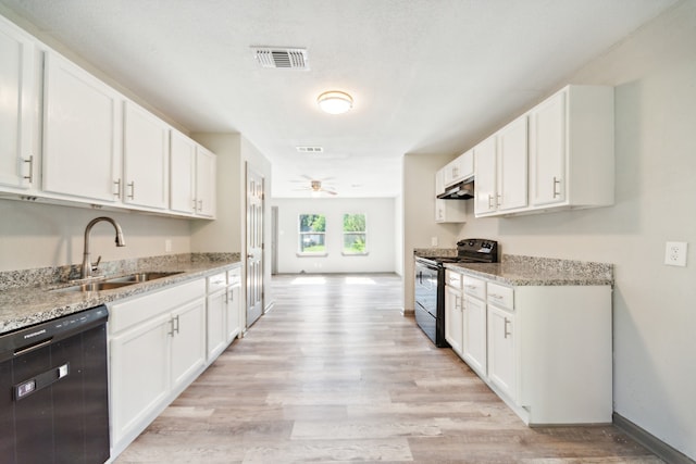 kitchen with white cabinets, sink, light wood-type flooring, and black appliances