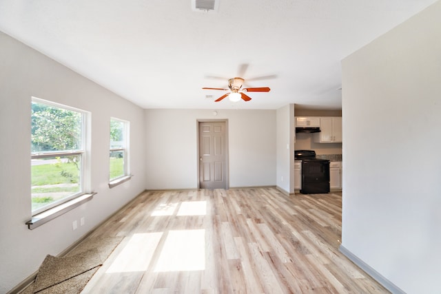 unfurnished living room featuring ceiling fan and light hardwood / wood-style floors