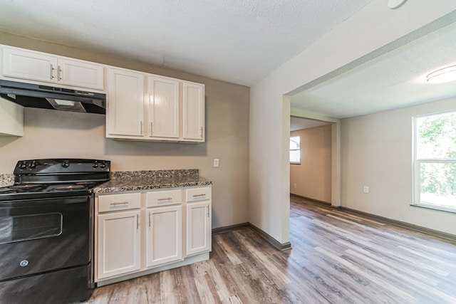 kitchen featuring white cabinetry, black electric range oven, light hardwood / wood-style flooring, and fume extractor