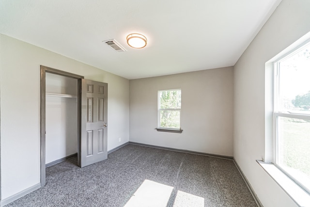 unfurnished bedroom with carpet and a closet