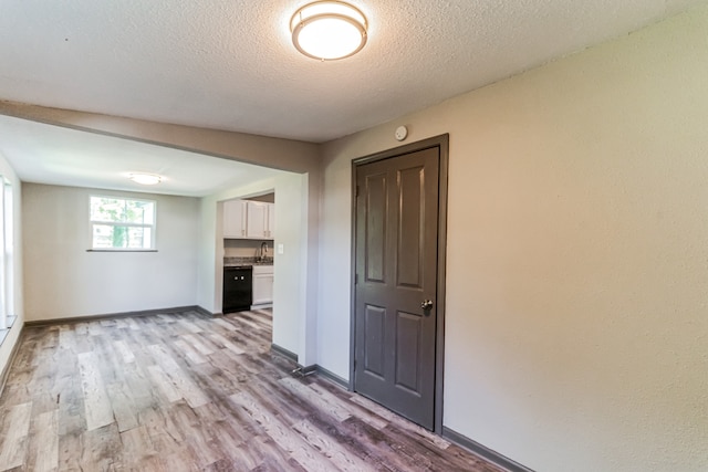 interior space with hardwood / wood-style flooring and a textured ceiling