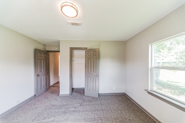 unfurnished bedroom with a closet and carpet flooring