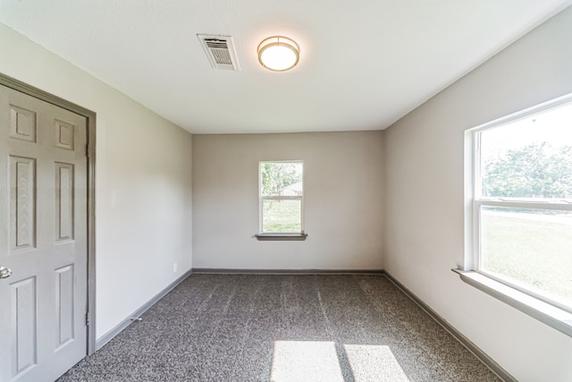 unfurnished bedroom featuring dark carpet