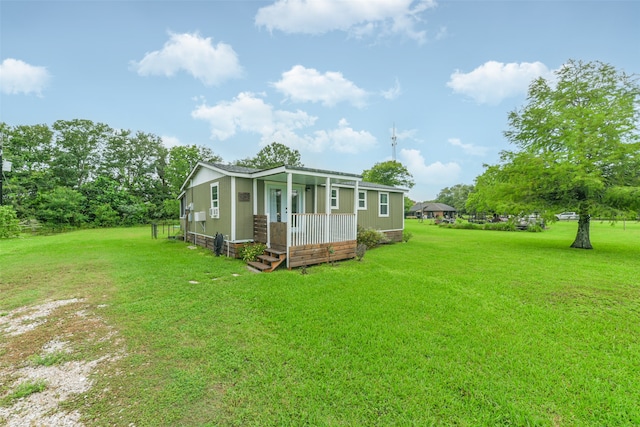 back of house with a lawn