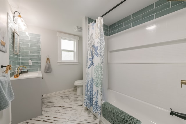 full bathroom with tile floors, vanity with extensive cabinet space, toilet, and shower / bathtub combination with curtain