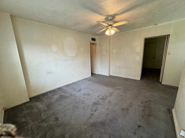 carpeted empty room featuring a textured ceiling and ceiling fan