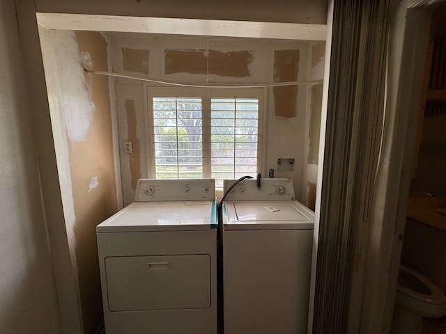 clothes washing area with washer and dryer