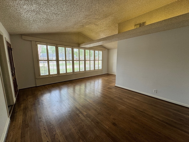 unfurnished room featuring vaulted ceiling, dark wood-type flooring, and plenty of natural light