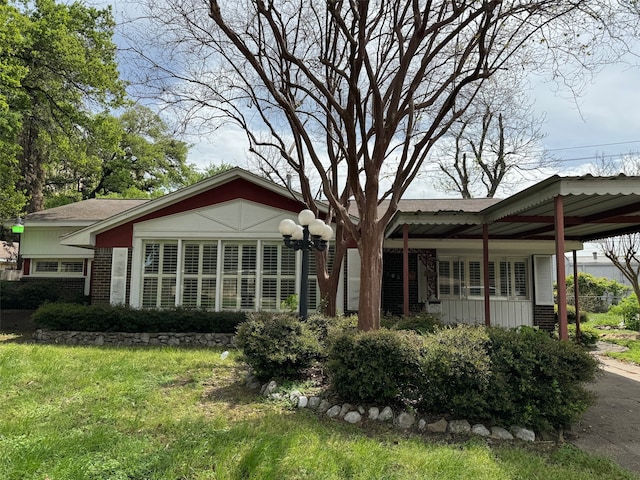 back of house featuring a yard and a carport