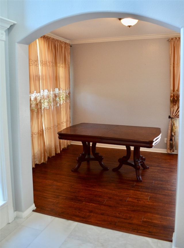 dining room with ornamental molding and hardwood / wood-style flooring