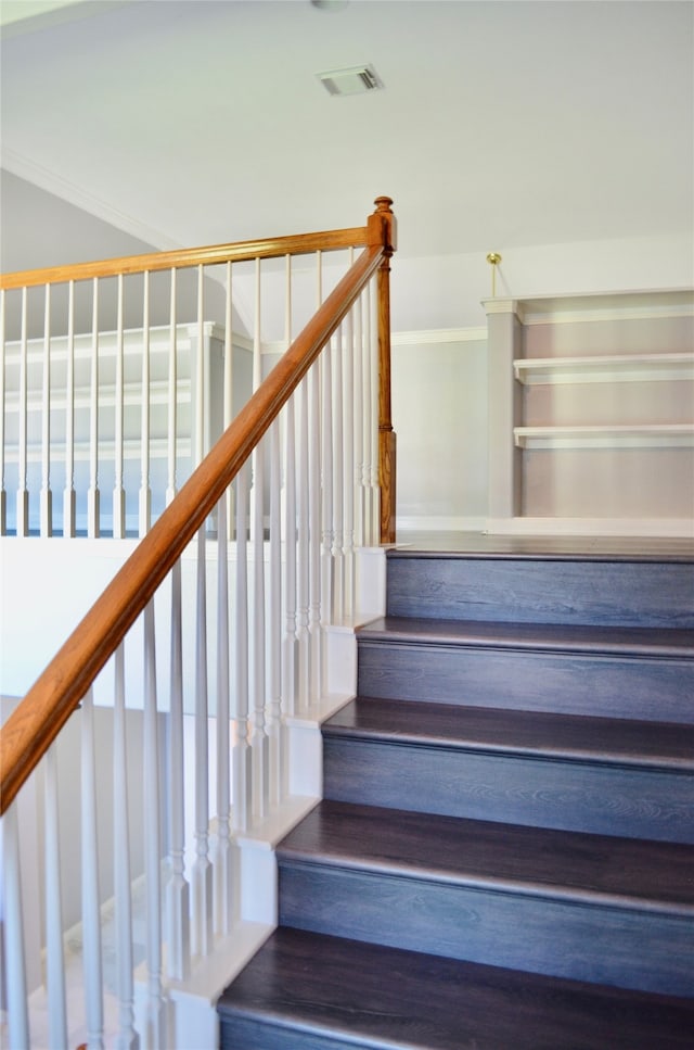 stairs featuring hardwood / wood-style floors