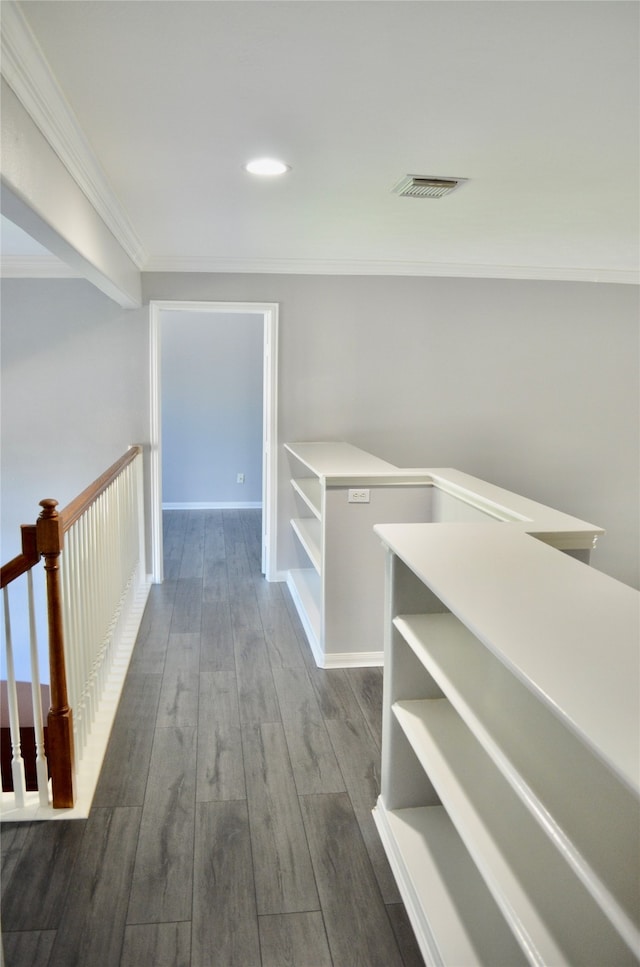 hall with ornamental molding and dark wood-type flooring