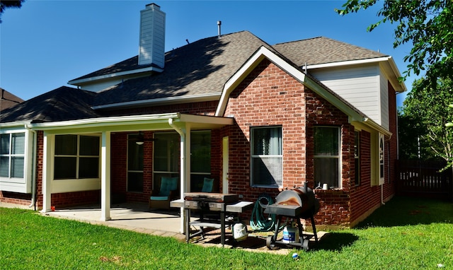 back of property featuring a patio and a yard