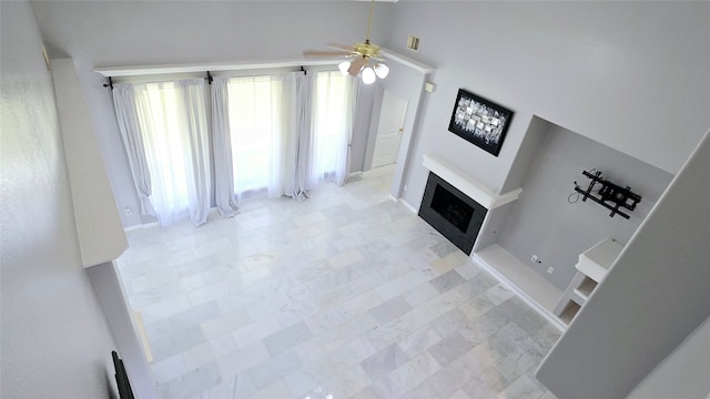 unfurnished living room featuring ceiling fan