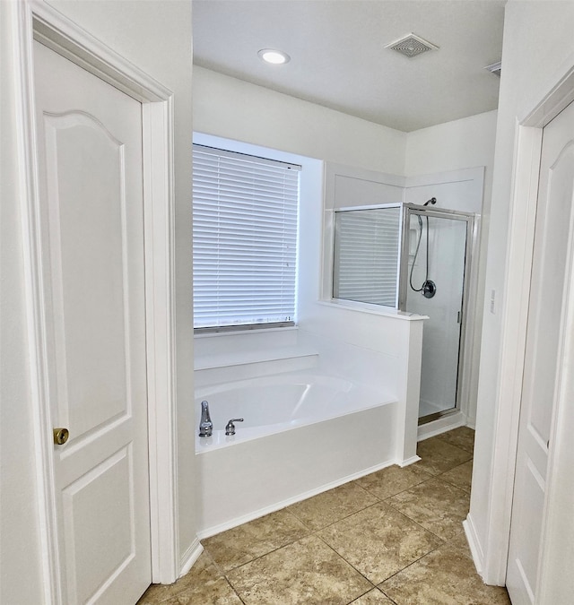 bathroom featuring tile patterned flooring and separate shower and tub